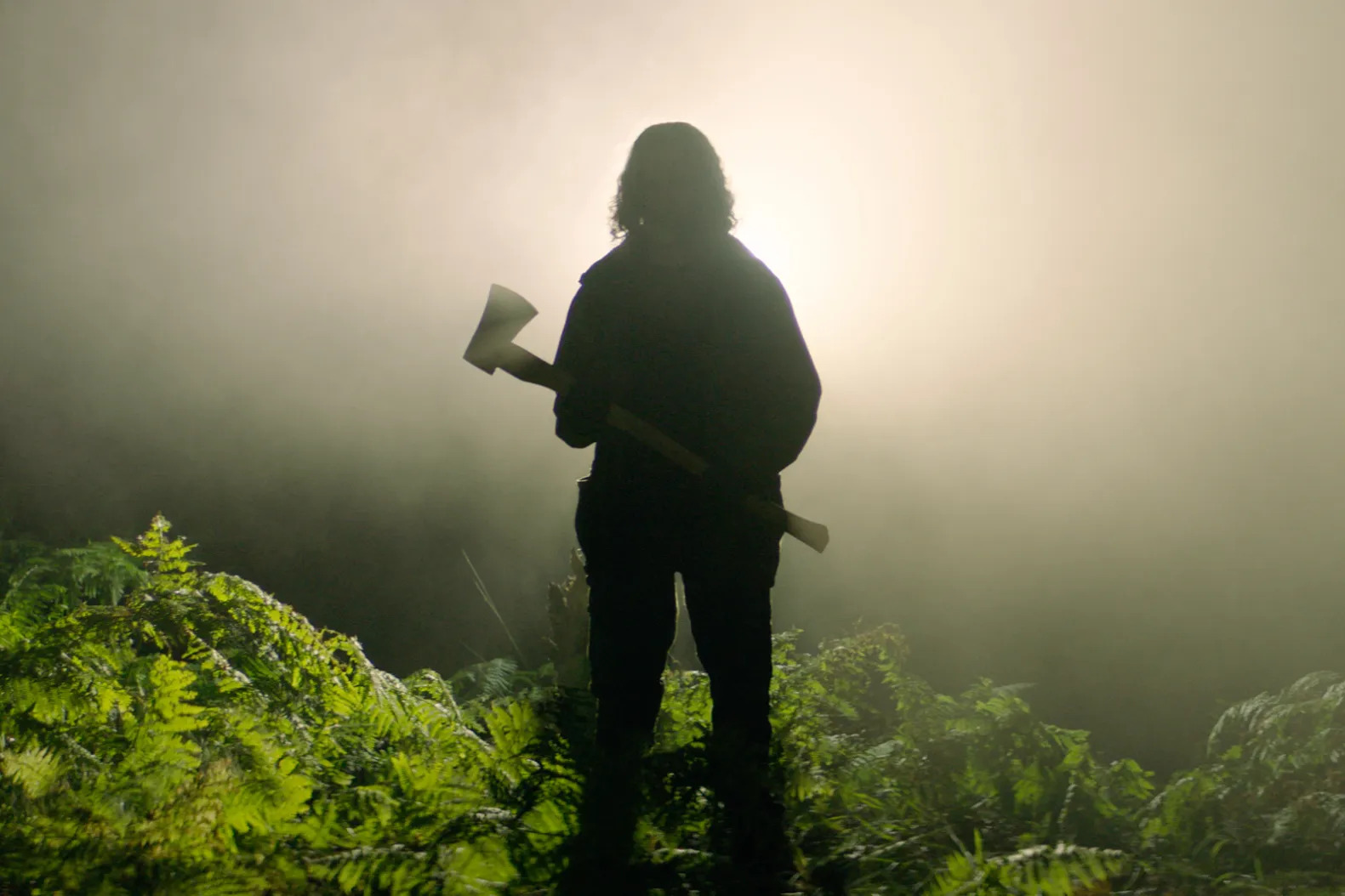 A woman holdng an axe in Ben Wheatley's In the Earth