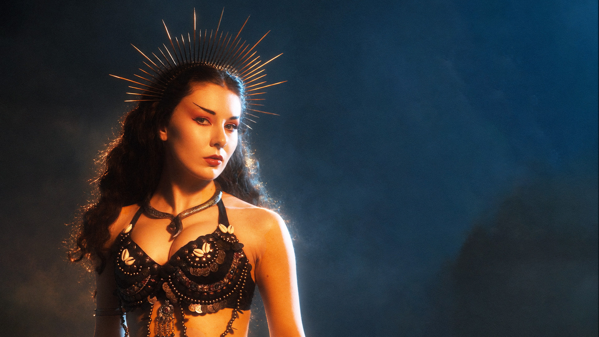 Megan Tremethick as Nemain, wearing a spiked crown in The Slave and the Torturer.