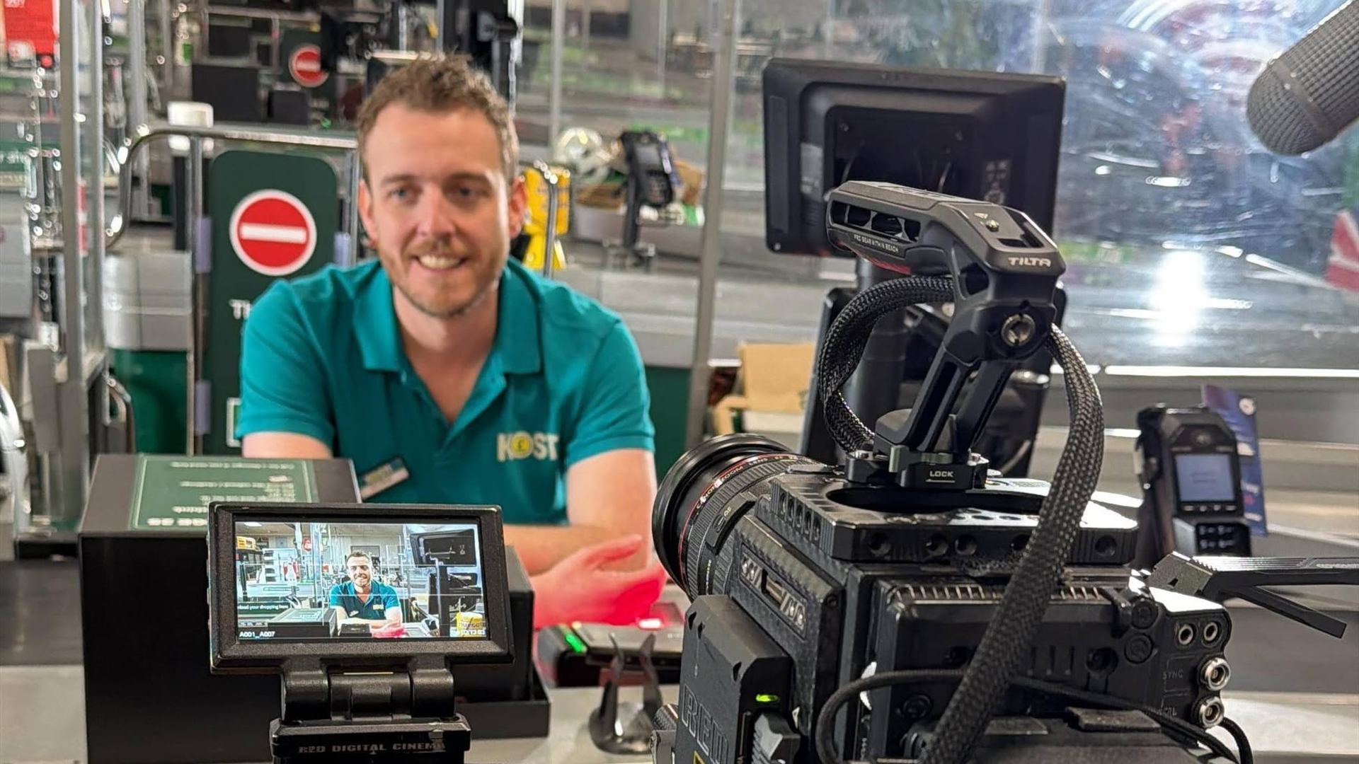 Joe Acres beside a camera during filming.