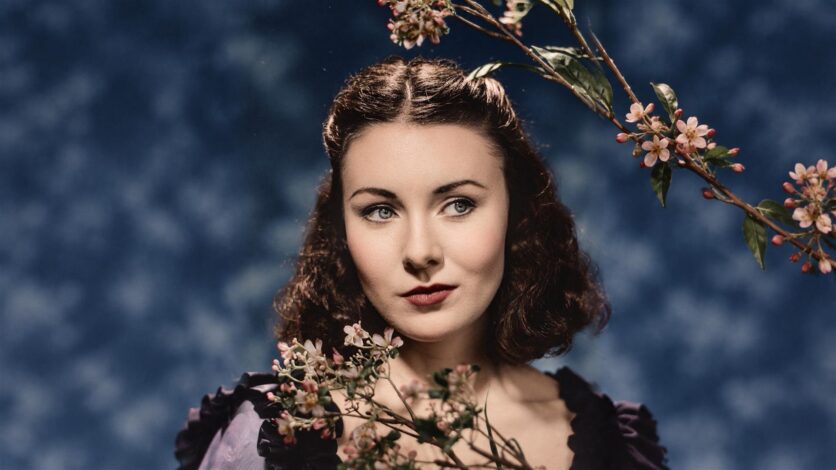 Megan Tremethick with pink blossom against a blue background.